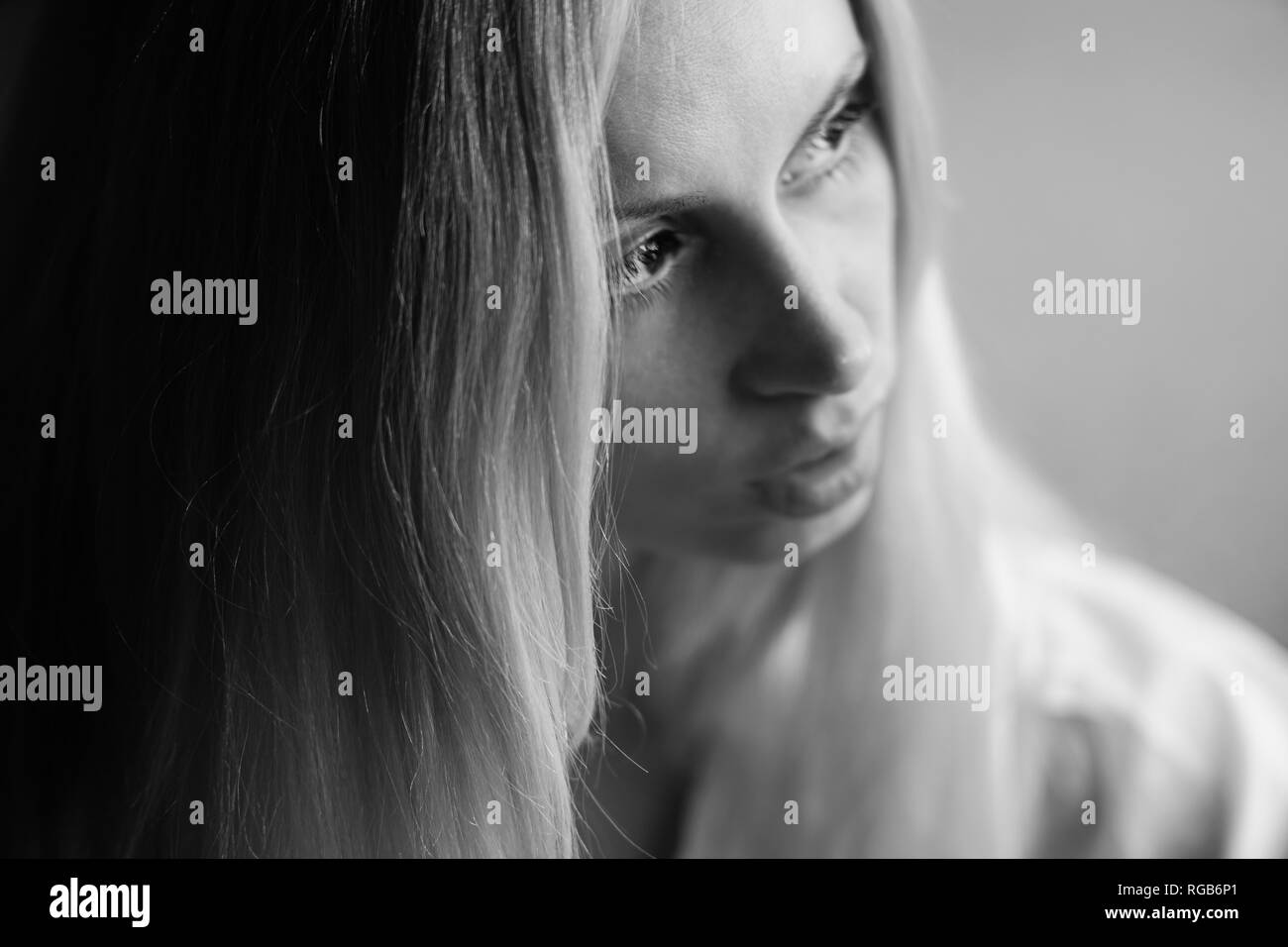 Portrait of a young girl with a pensive serious look to the side. Selective soft focus Stock Photo