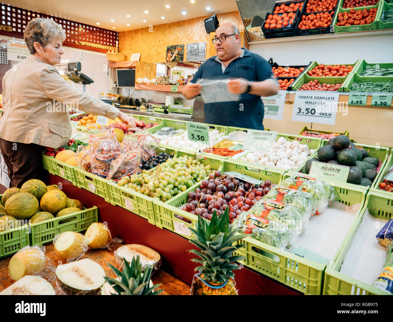 FELANITX, PALMA DE MAJORCA, SPAIN - MAY 10, 2018: Spanish senior woman buying fruits and vegetables on the local farmers market in central square Stock Photo