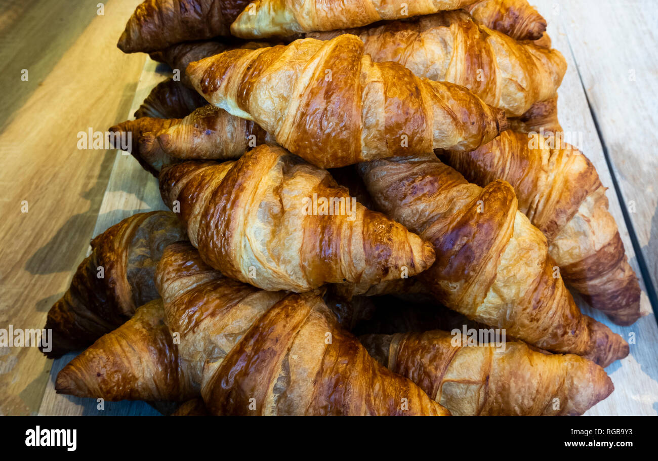 Fresh baked croissants in a bakery shop window Stock Photo