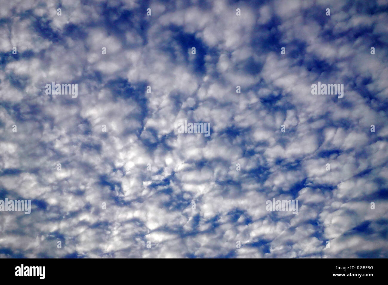 Clouds form a unique pattern in the blu sky. Stock Photo