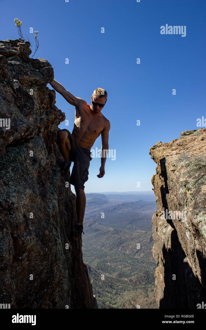 jung man standing between 2 rocks on St Mary's Peak from the Flinders Ranges National Park, Australia Stock Photo
