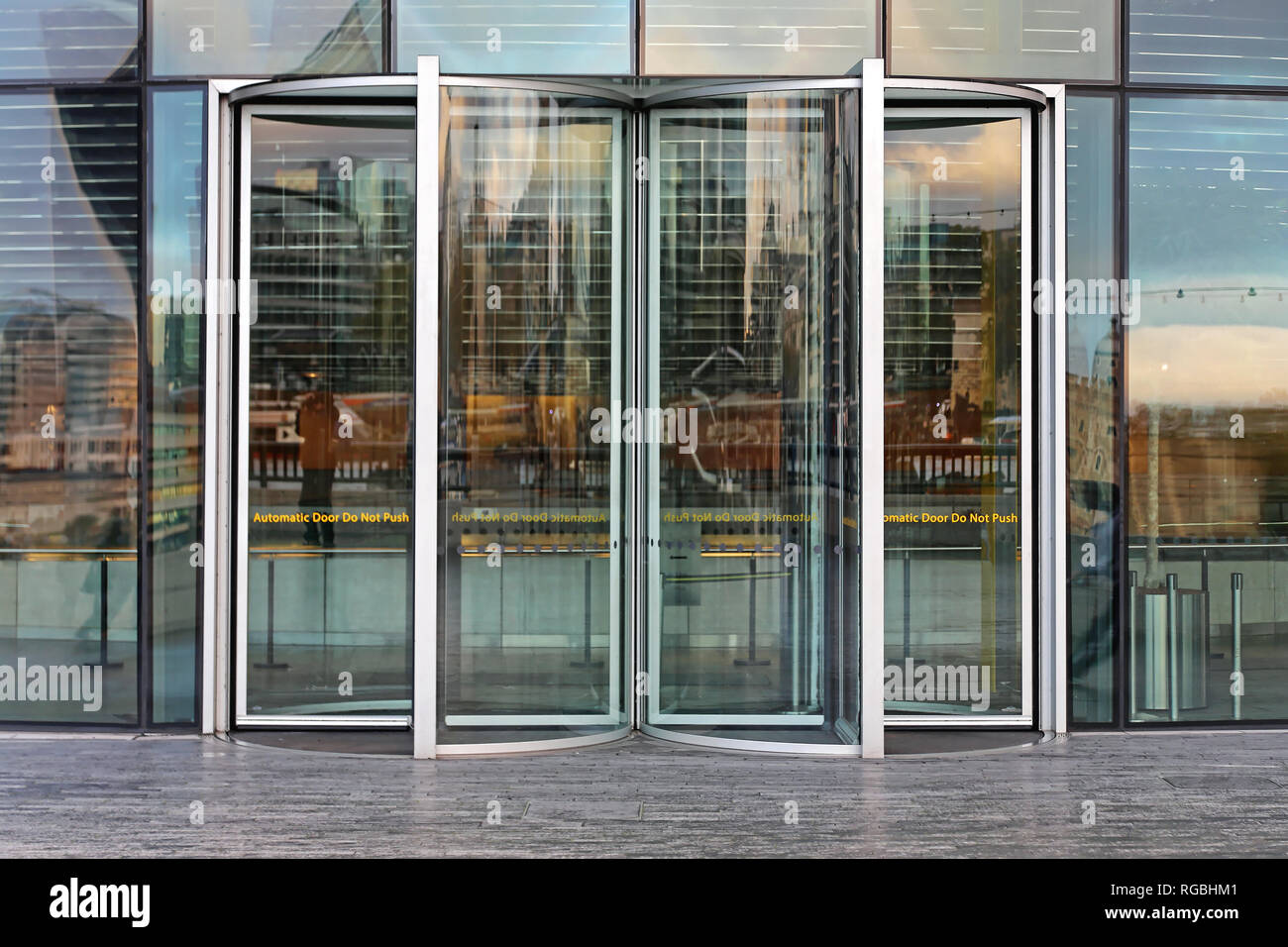 Automatic Revolving Door at Glass Office Building Stock Photo