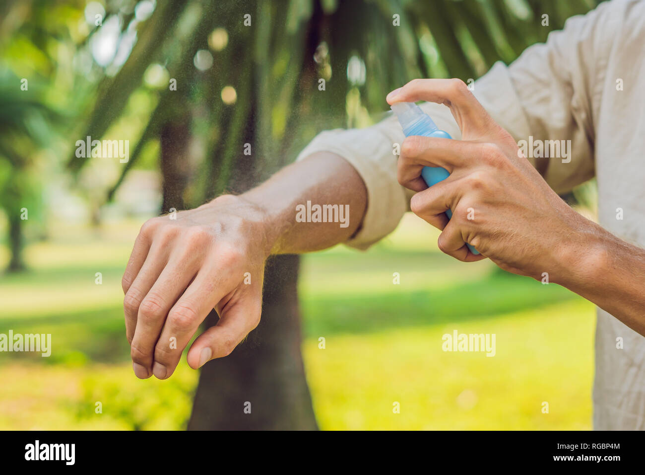 Young man spraying mosquito insect repellent in the forrest, insect protection Stock Photo Alamy