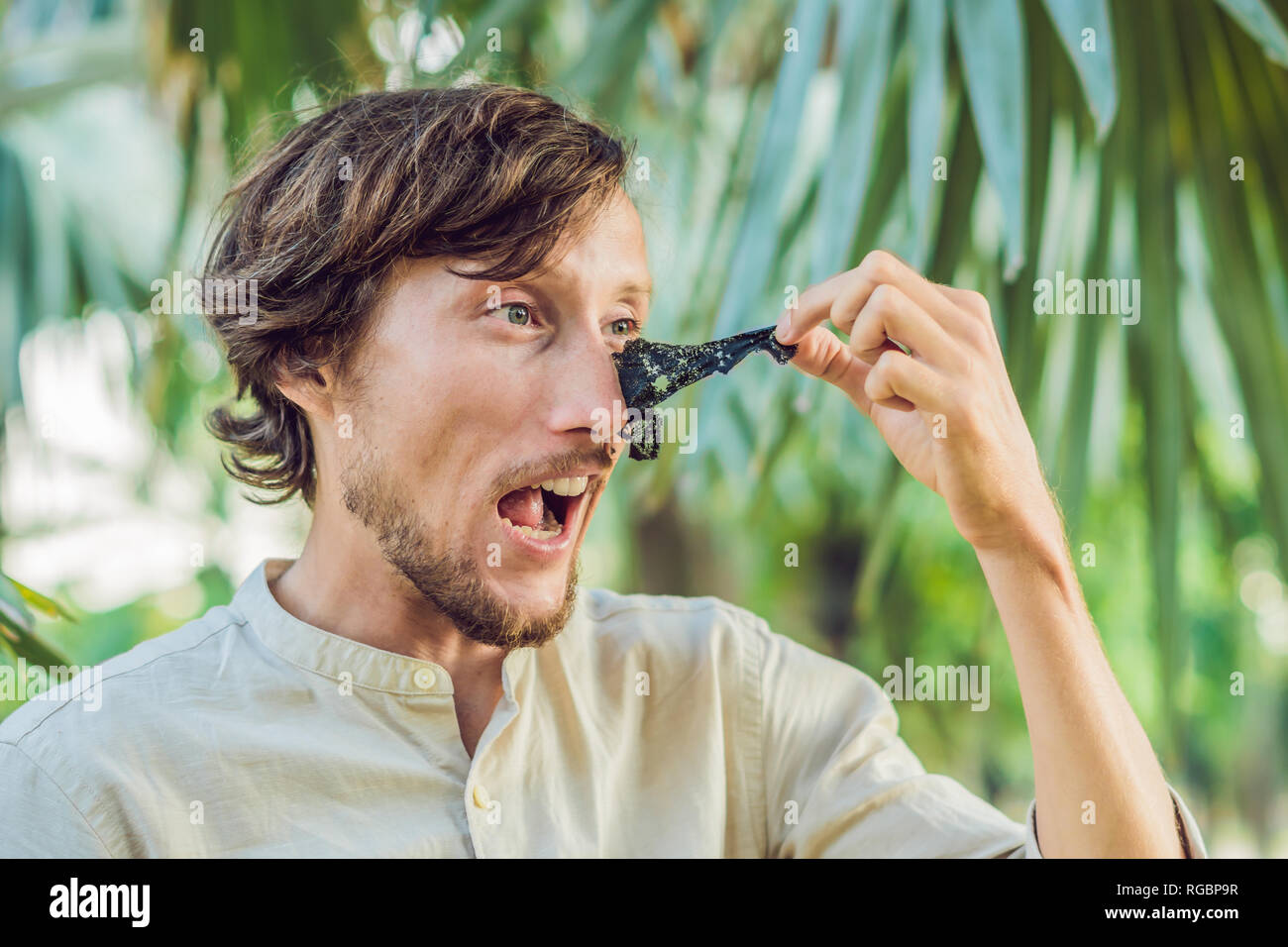 Happy Man With Black Mask On The Face Photo Of Man Receiving Spa