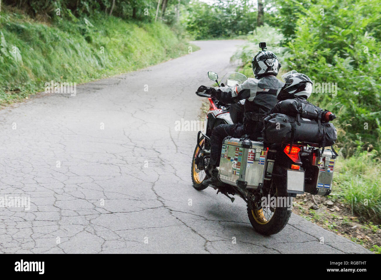 Father and son on a motorbike trip on a country road Stock Photo