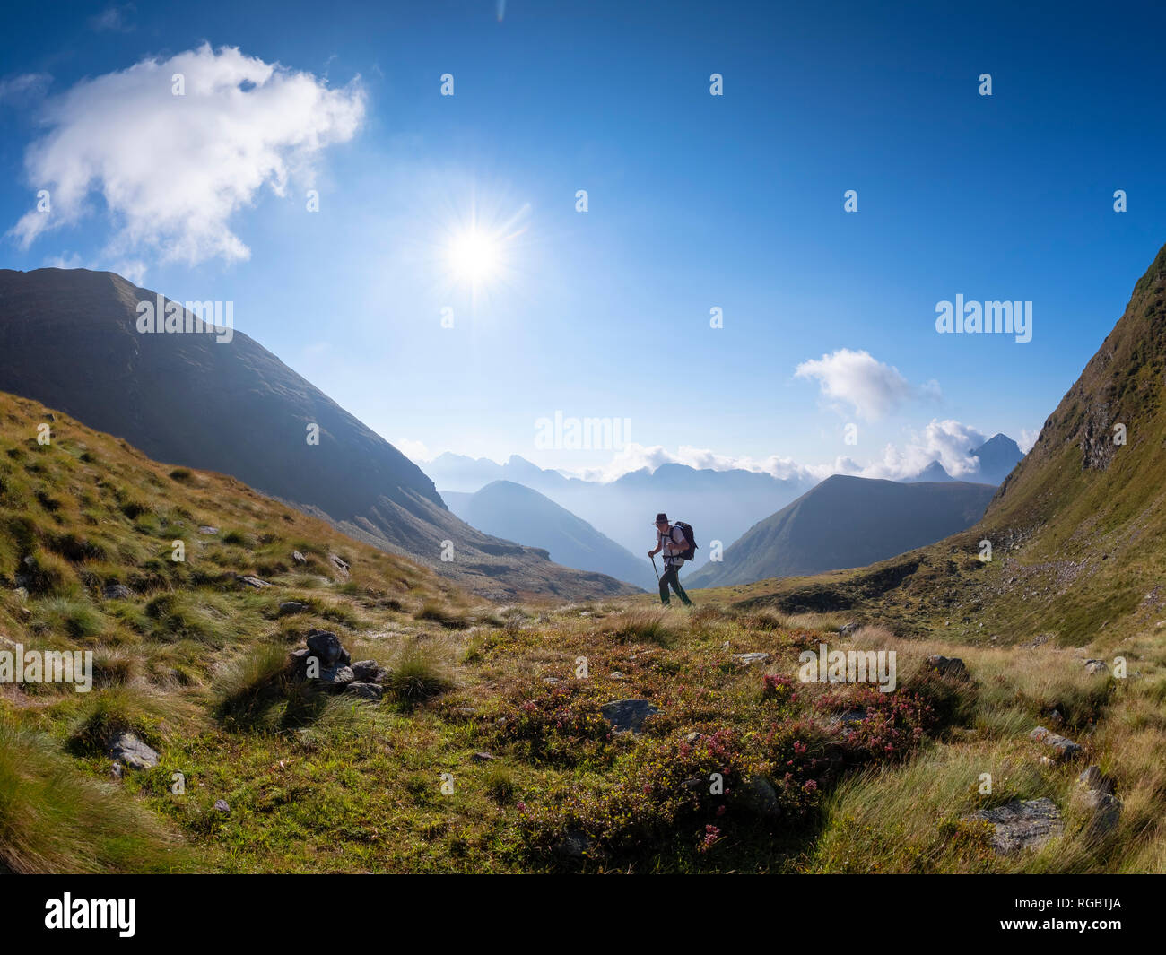 Italy, Lombardy, Bergamasque Alps, hiker on the way to Passo del Gatto, Cima Bagozza and Mount Camino Stock Photo