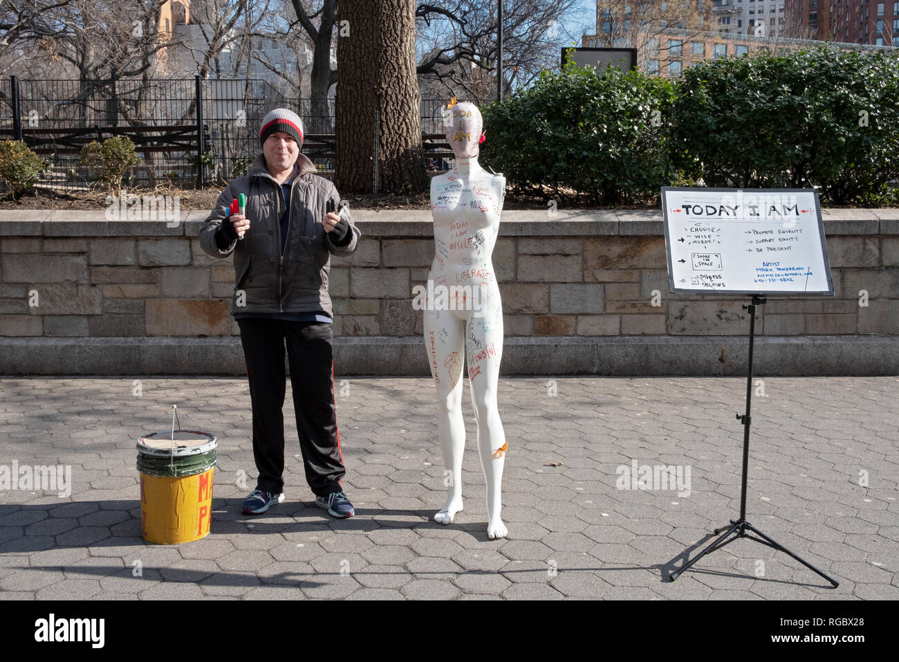 Performance artist Mark Panzarino in Union Square with an armless mannequin & magic markers. He asked passers bye to write something meaningful. Stock Photo