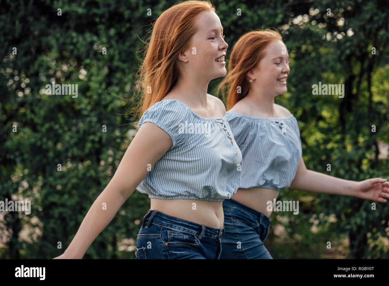 Redheaded twins running Stock Photo