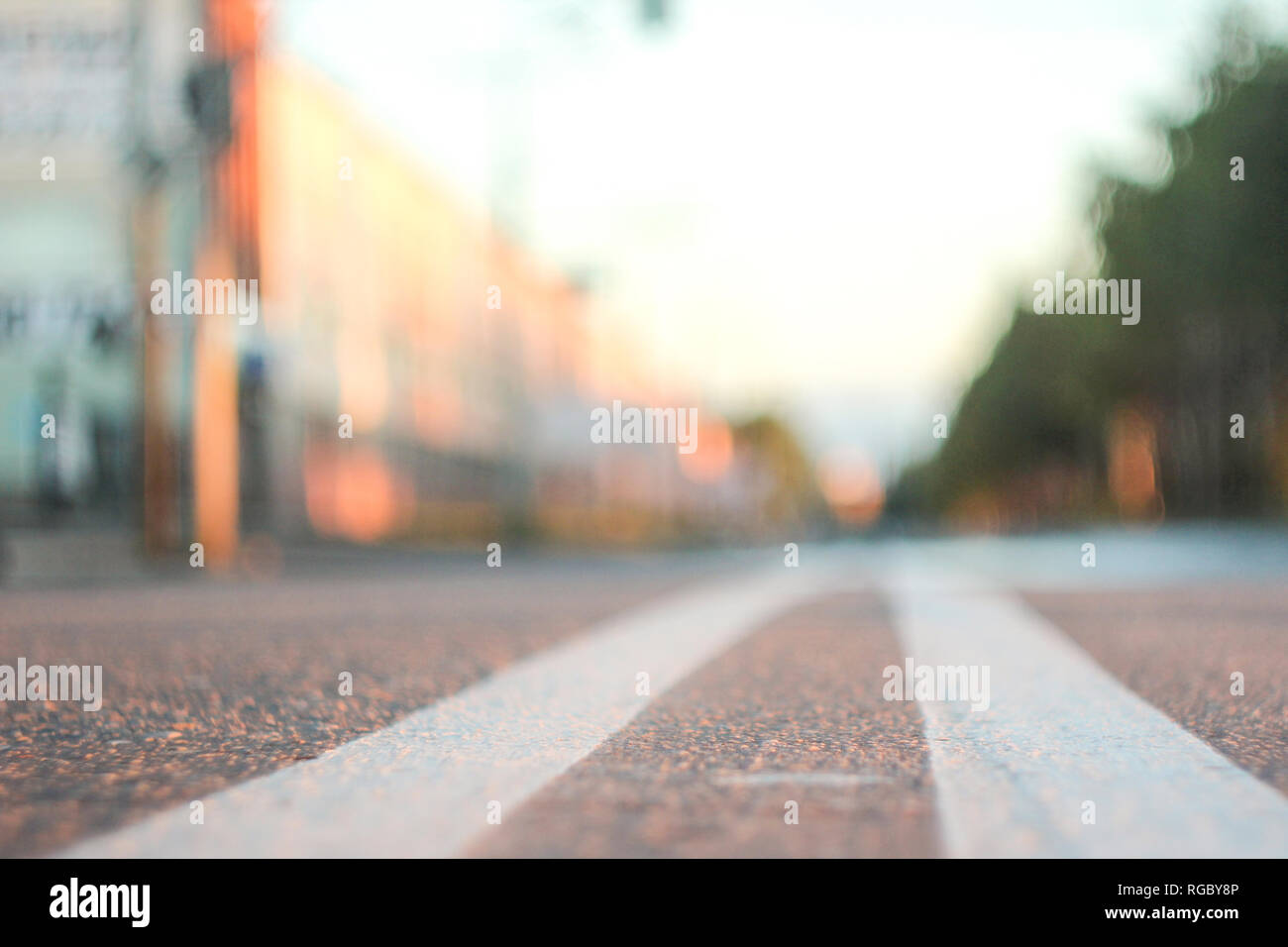 Photo of the road with a double solid strip with a small depth of field,  blurred background and variable focus for wallpaper at sunrise Stock Photo  - Alamy