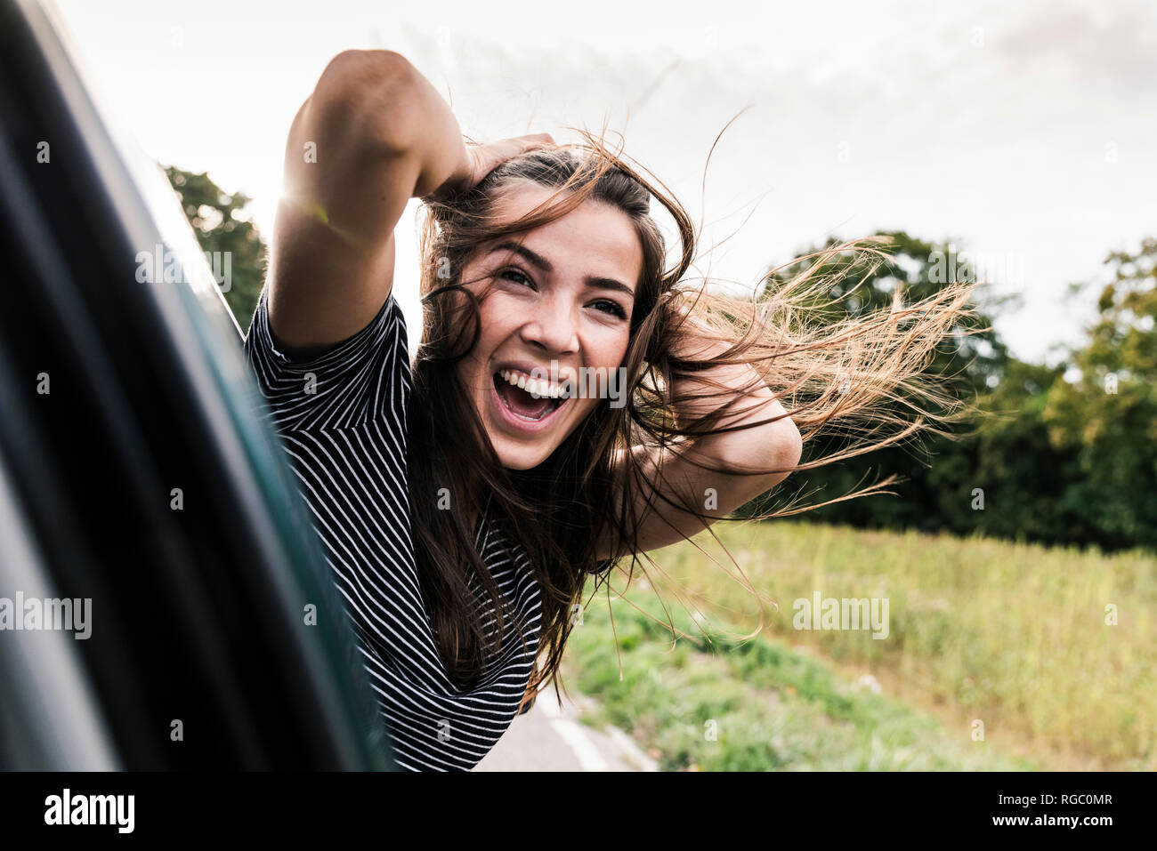 Woman feeling carefree on sunlit hi-res stock photography and images - Alamy