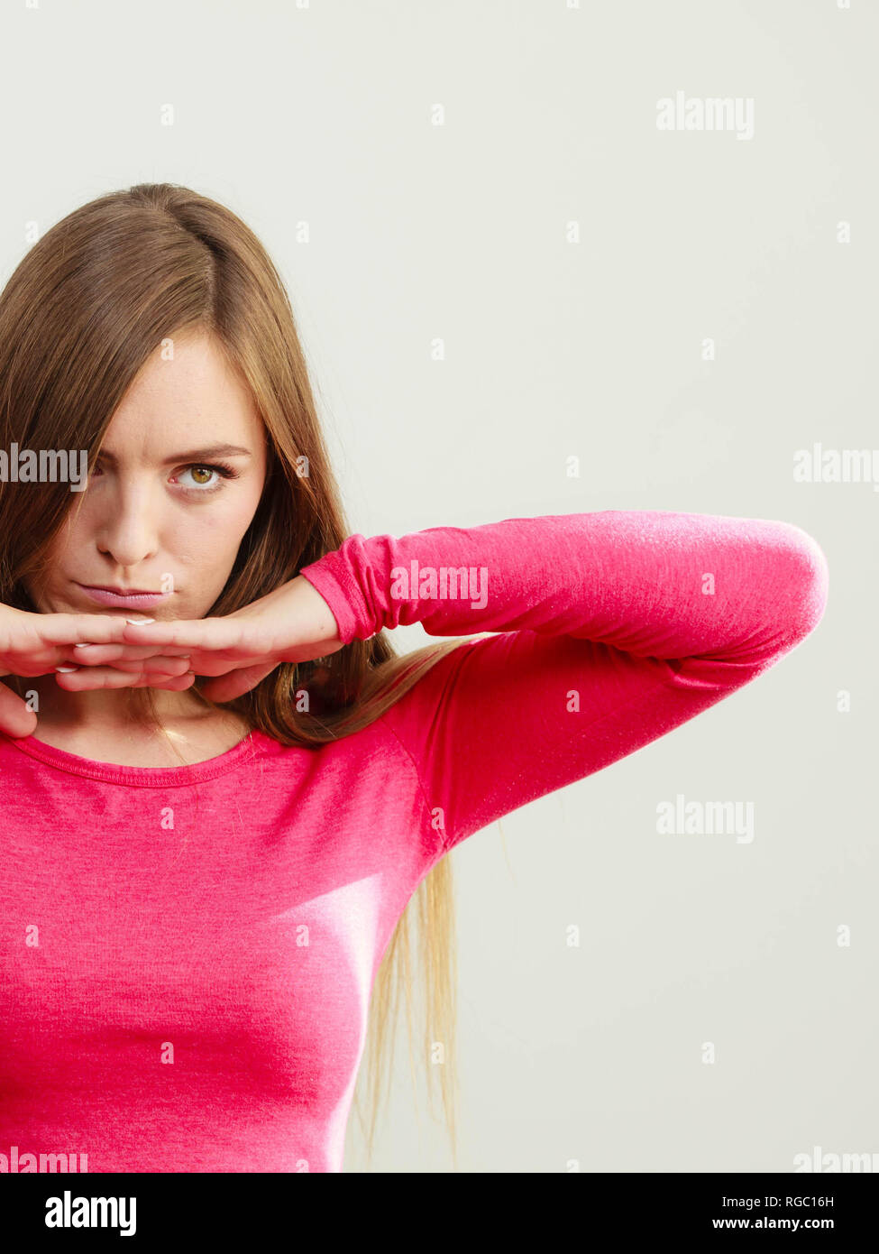 Young woman posing with hand under chin, serious face Stock Photo