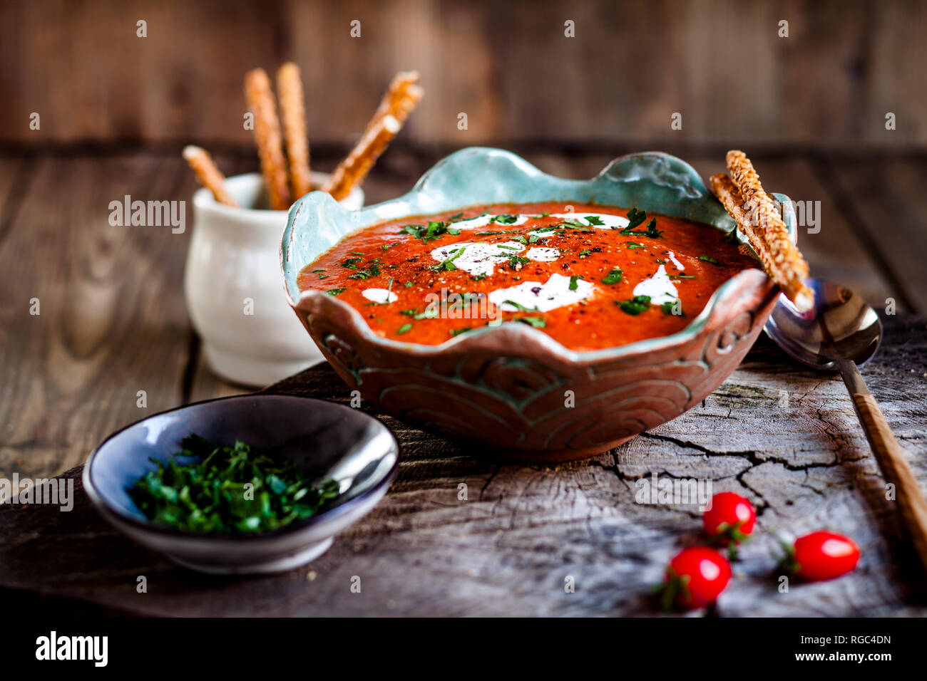 Tomato soup with sour cream and sesame sticks Stock Photo