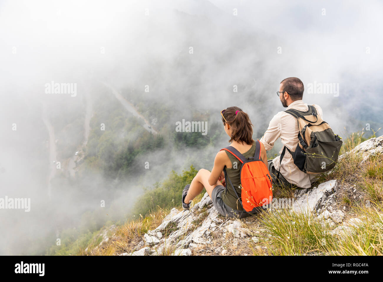 Italy, Massa, couple looking at the beautiful view in the Alpi Apuane Stock Photo