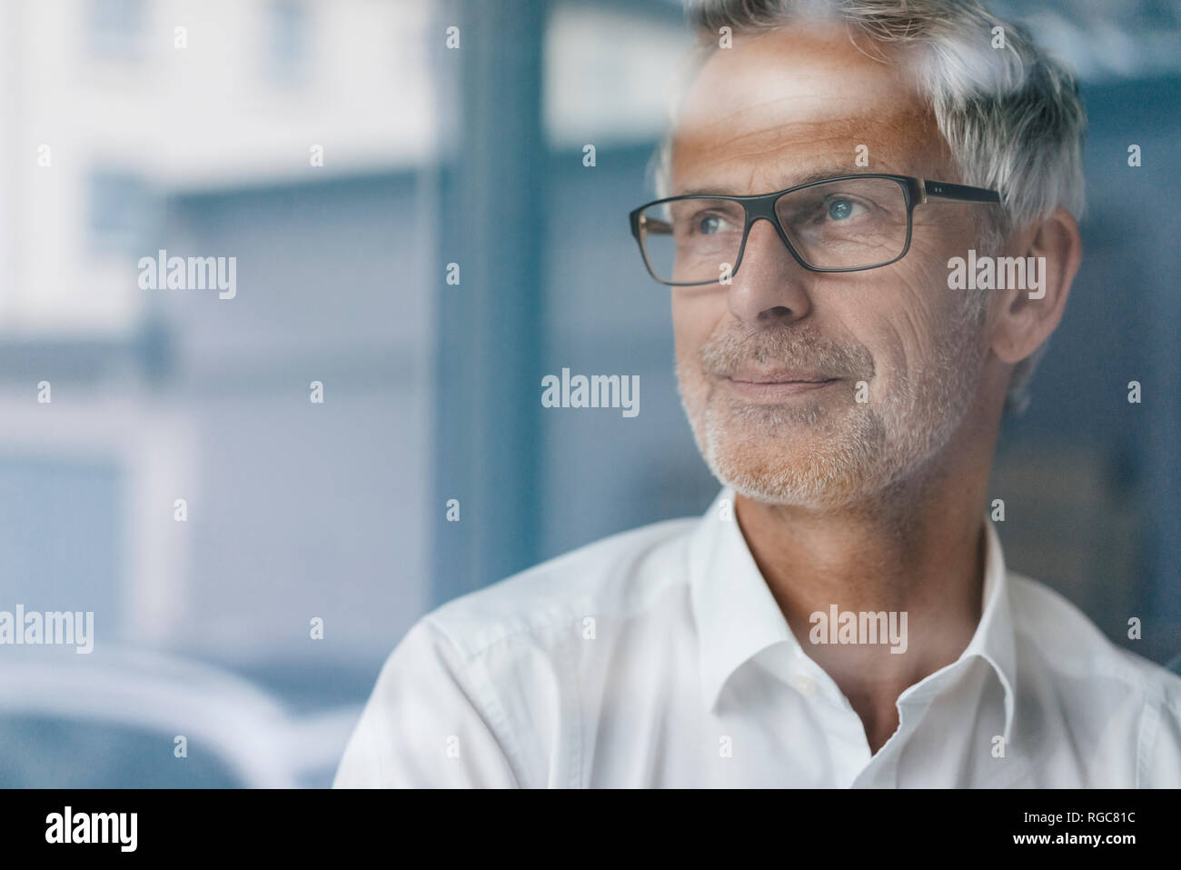 Successful manager looking out of window, thinking, portrait Stock ...