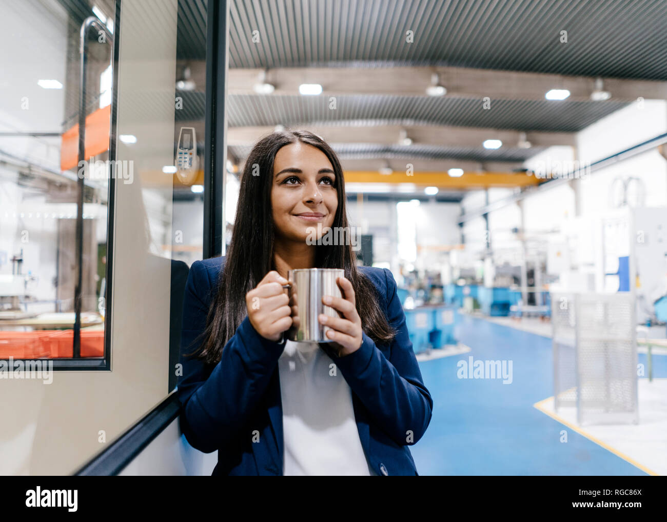 Confident woman working in high tech enterprise, drinking coffee Stock Photo