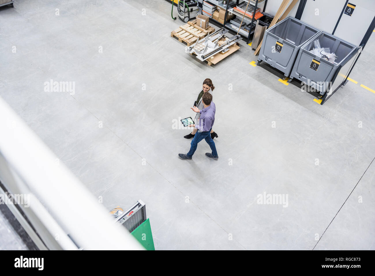 Businessman and woman walking in company, discussing new strategies Stock Photo