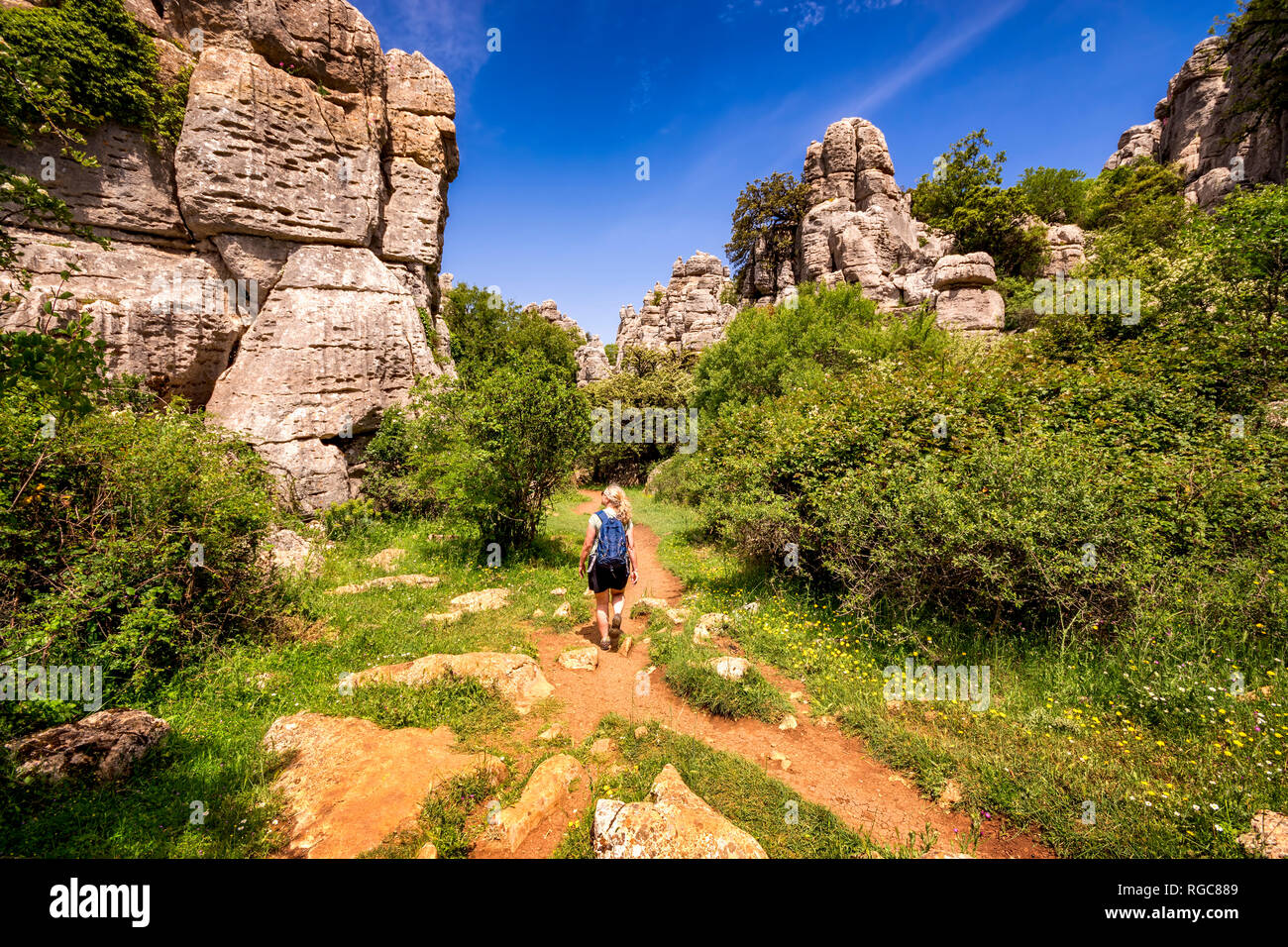 Spain, Málaga Province, Sierra del Torcal mountain range, El Torcal de Antequera nature reserve, female hiking Stock Photo