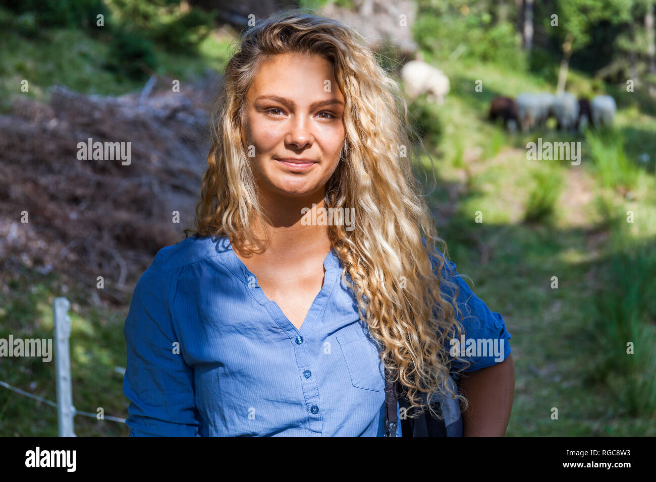 Germany, Bavaria, Oberammergau, portrait of smiling young woman on a hiking trip Stock Photo