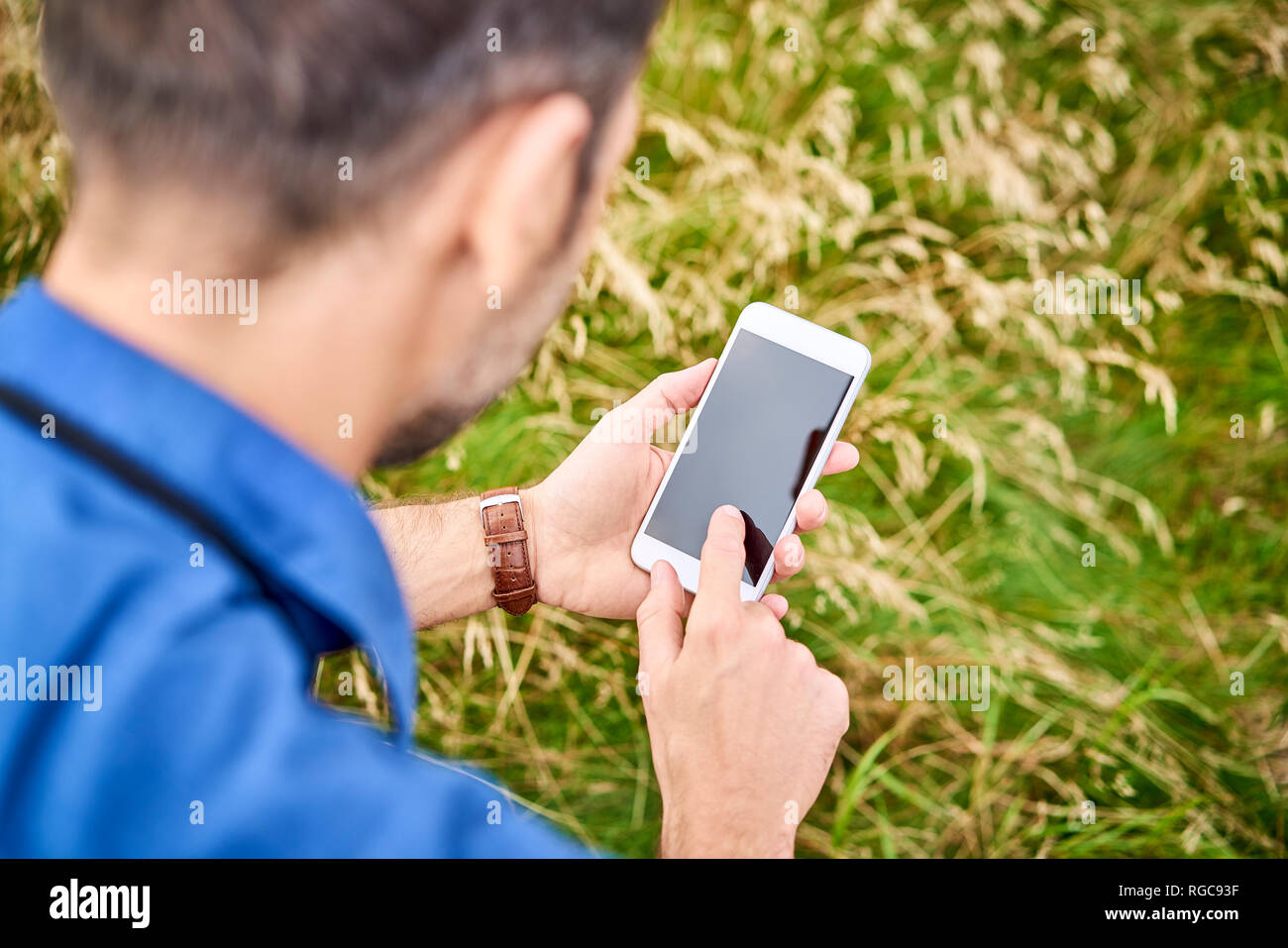 Close-up of man checking his cell phone during hiking trip Stock Photo