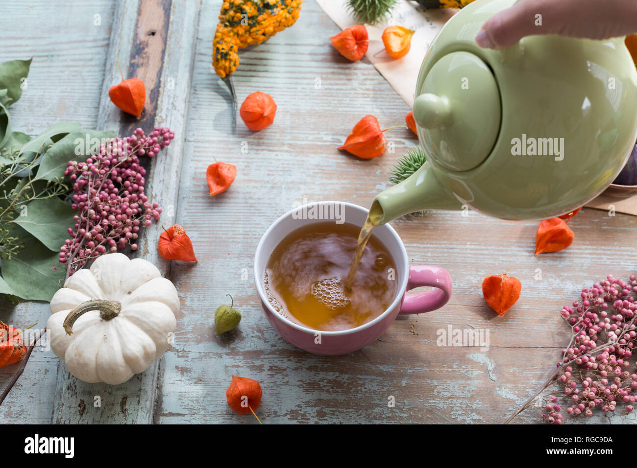 Woman's hand pouring tea in a cup Stock Photo