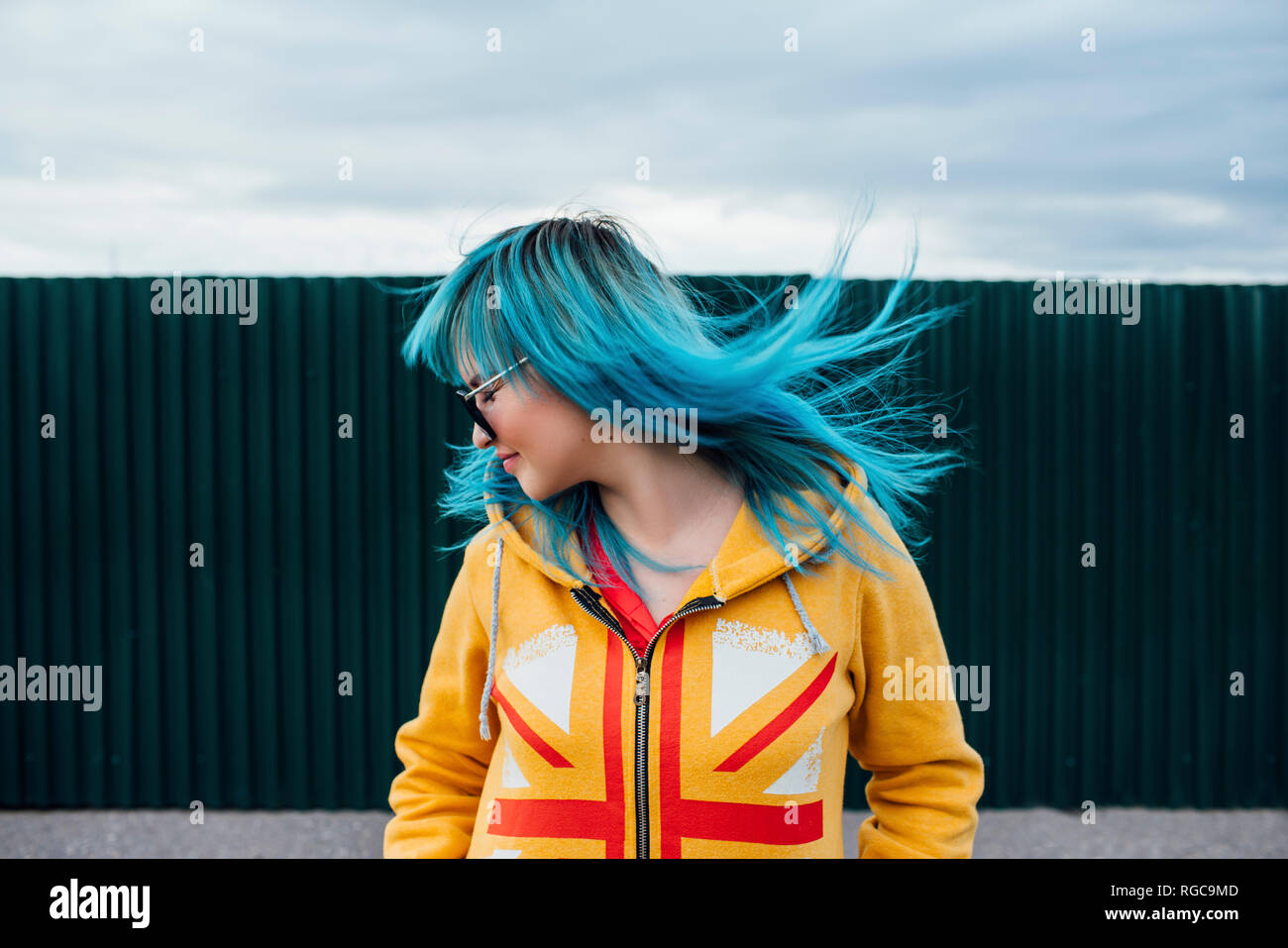 Young woman with blowing dyed blue hair Stock Photo