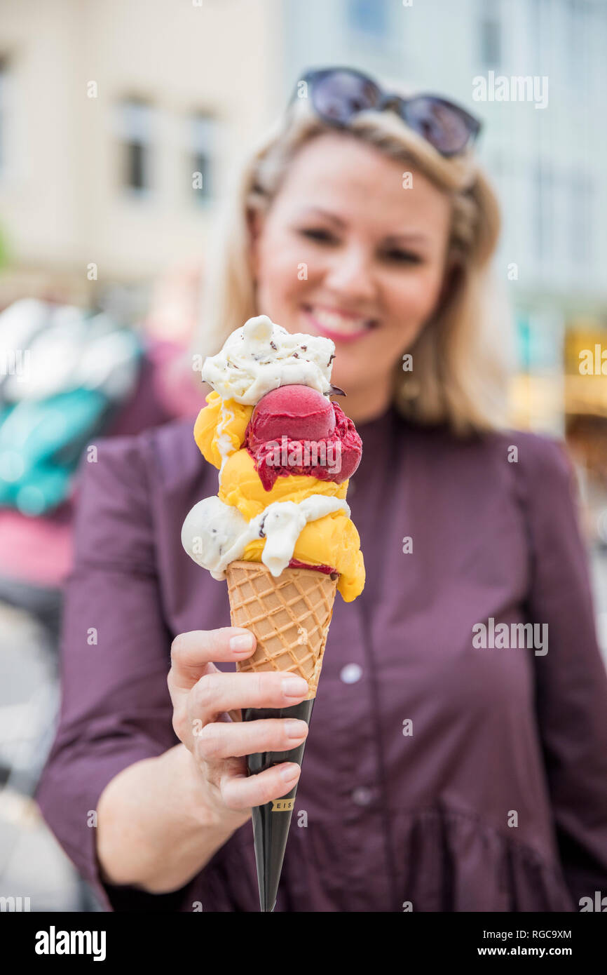 Woman holding ice cream cone with various sorts of ice cream Stock Photo