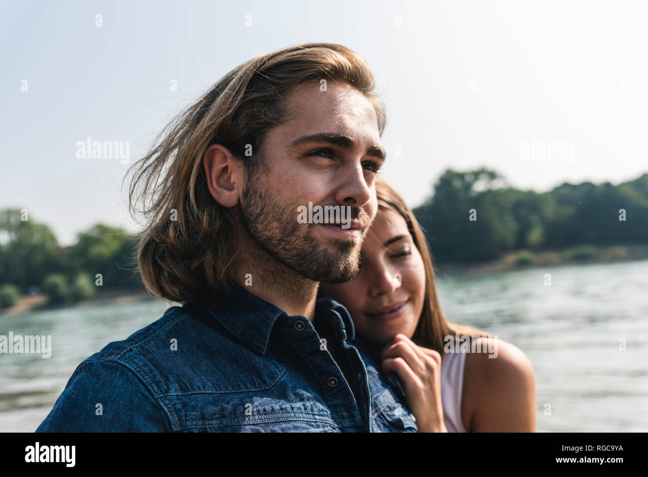 Portrait of young couple in love at the riverside Stock Photo