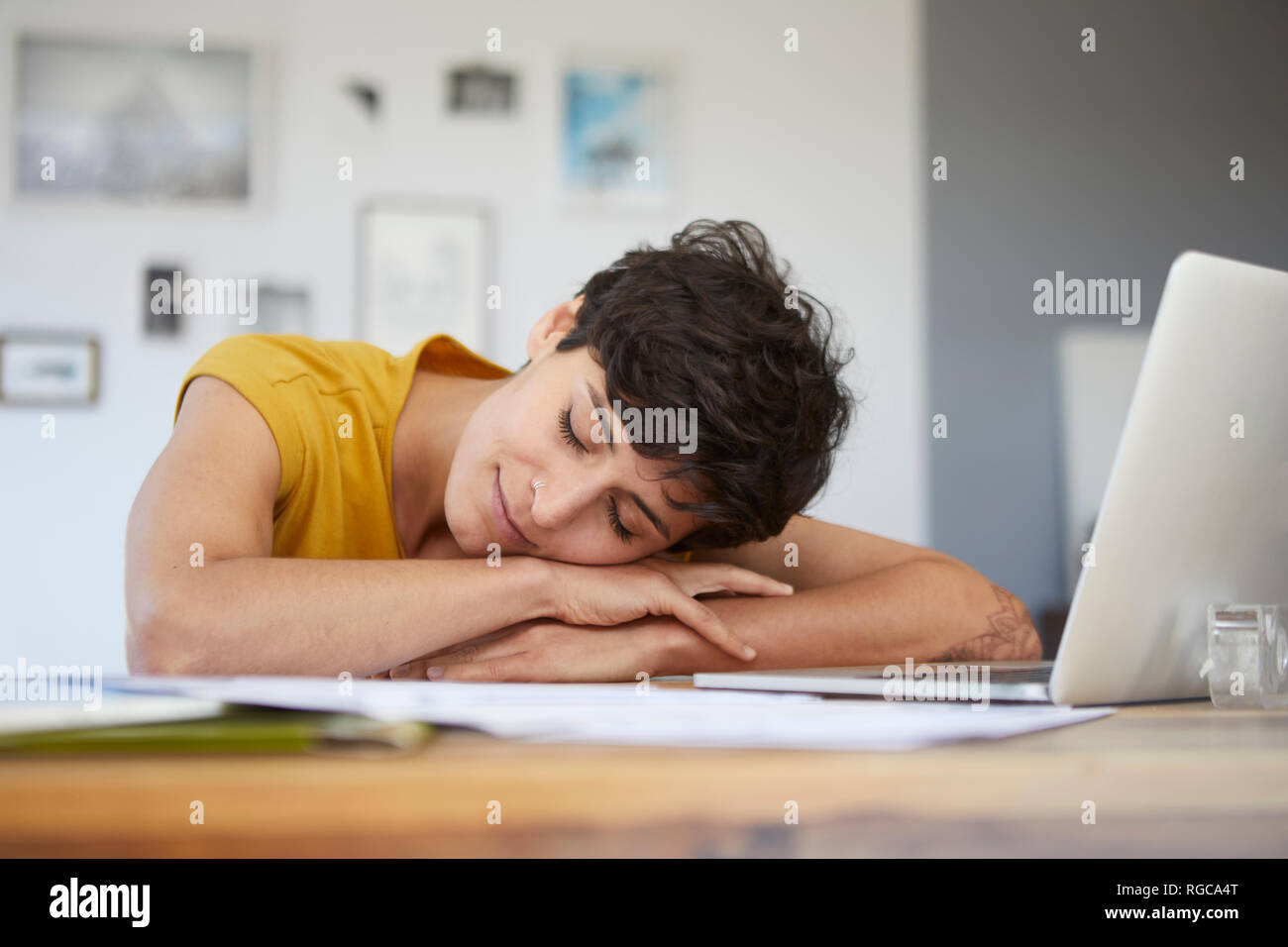 Woman at home resting on table with laptop Stock Photo