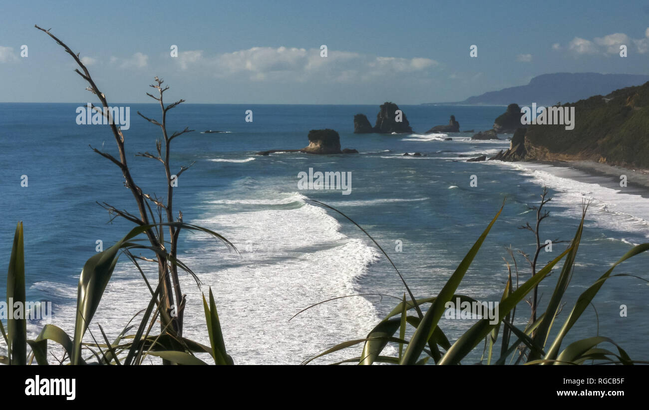 surf rolls in at nine mile, near greymouth, on the west coast of new zealand's south island Stock Photo