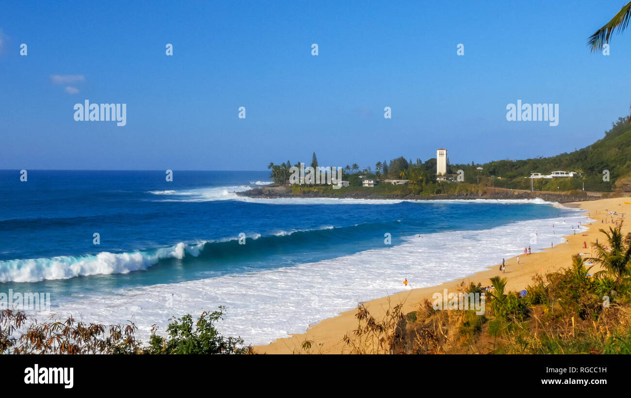 a wave breaks on the beach at the famous big wave location, waimea bay in hawaii Stock Photo Alamy