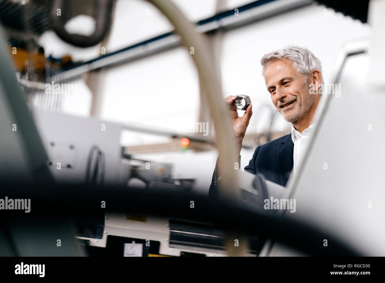 Manager in high tech enterprise, checking machine parts Stock Photo Alamy
