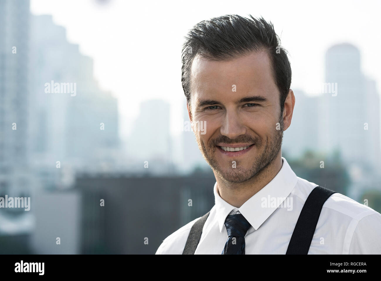 Portrait of business man on city rooftop Stock Photo