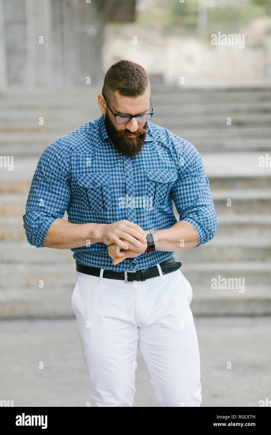 Bearded hipster businessman checking the time Stock Photo