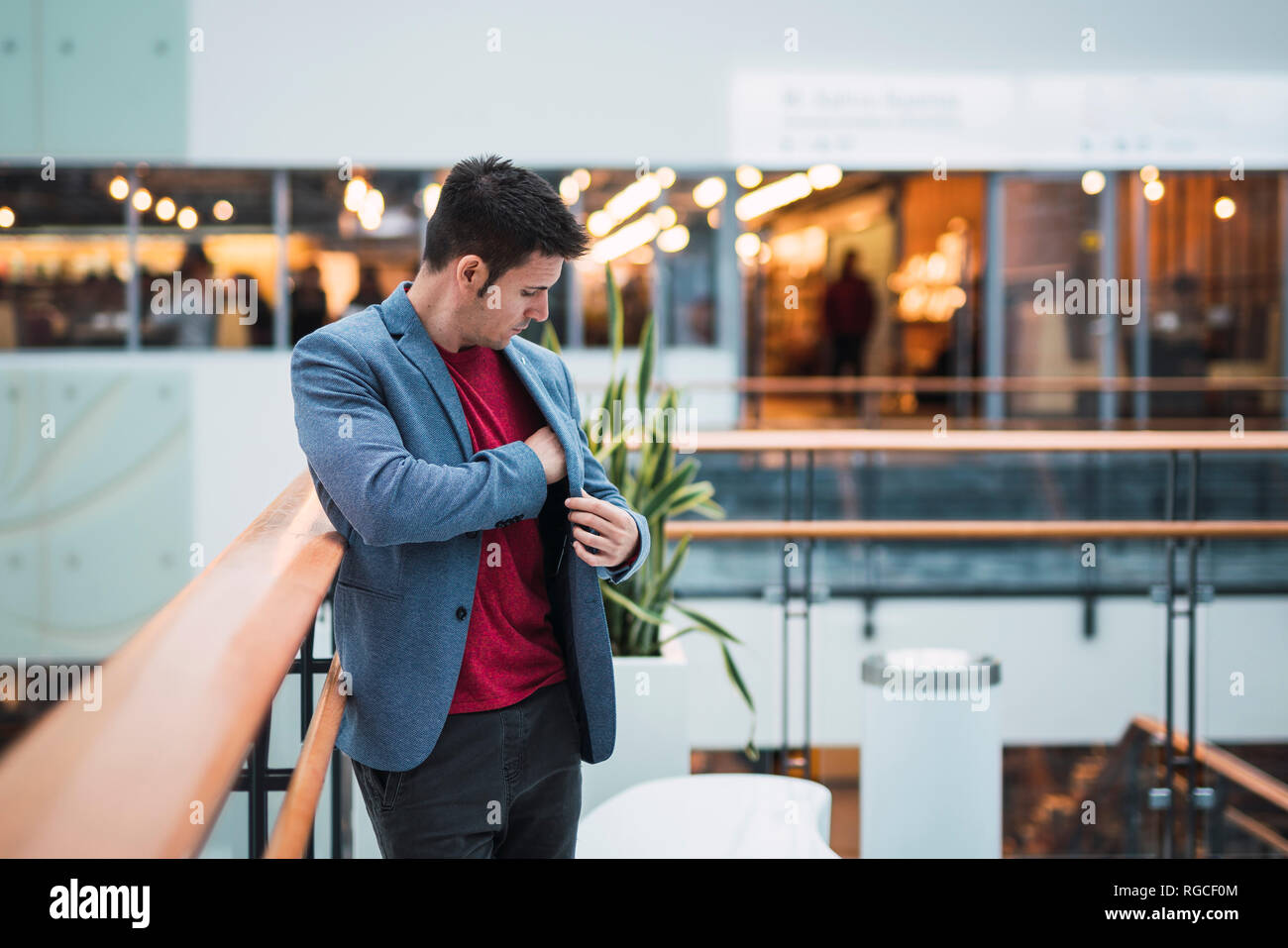 Man In Building Businessman in lobby of a modern building, using Stock Photo - Alamy