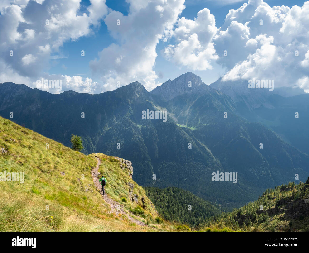 Italy, Lombardy, Valle di Scalve, hiker on hiking trail, Mount Camino Stock Photo