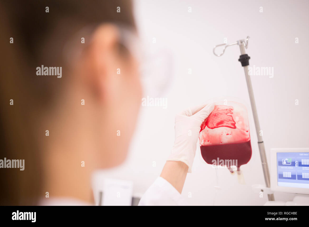 Scientist working with blood bag in lab Stock Photo