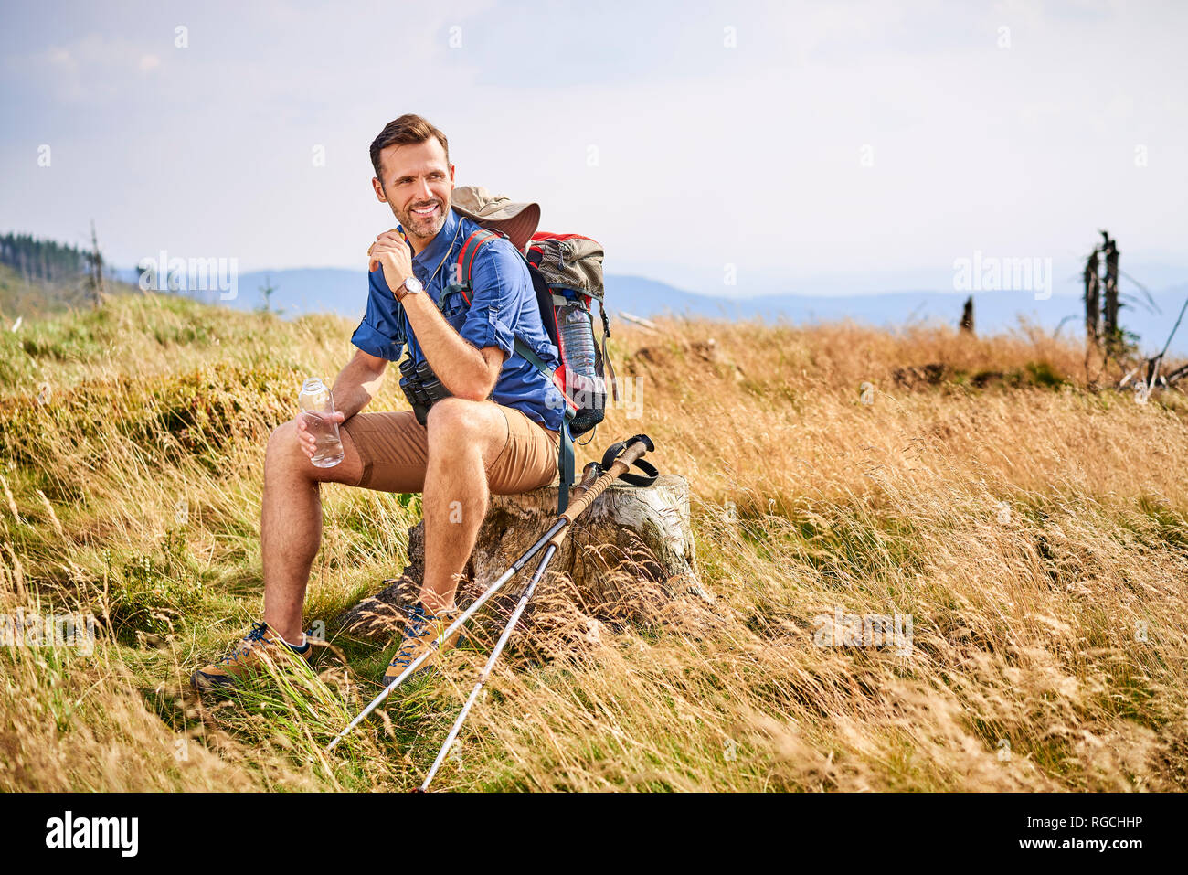 Smiling man resting during hiking trip Stock Photo