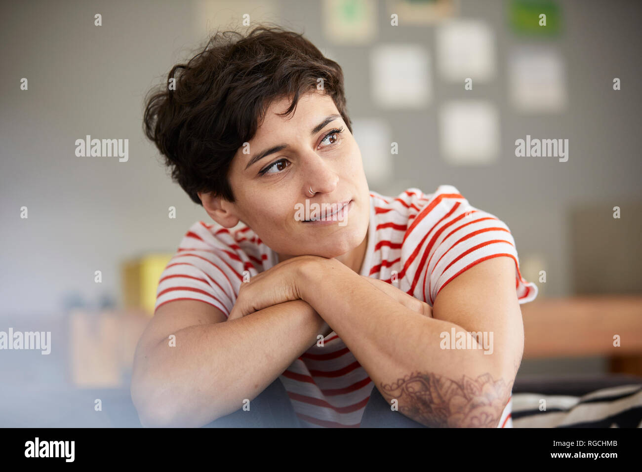 Portrait of woman at home thinking Stock Photo