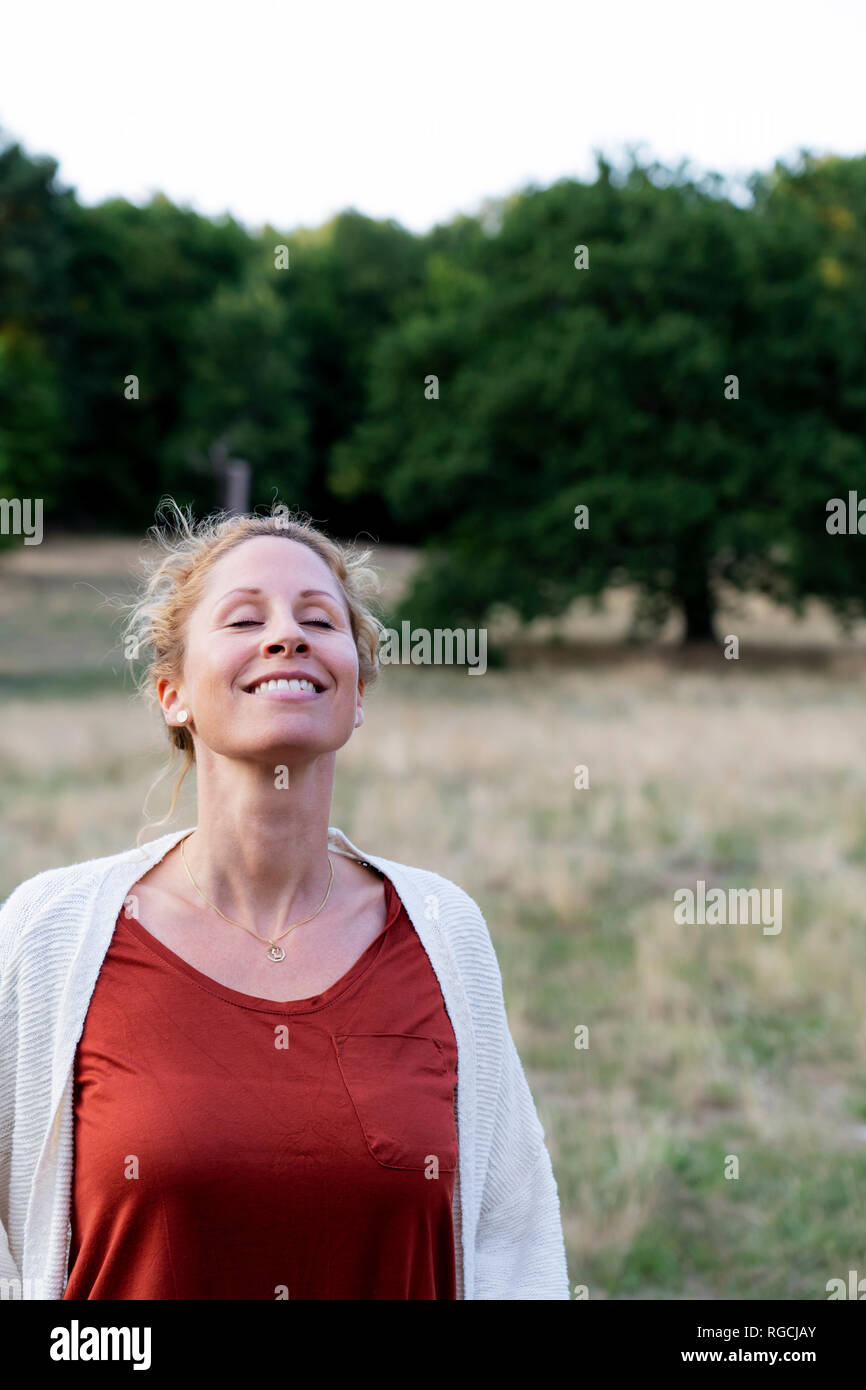 Portrait of happy woman enjoying nature Stock Photo