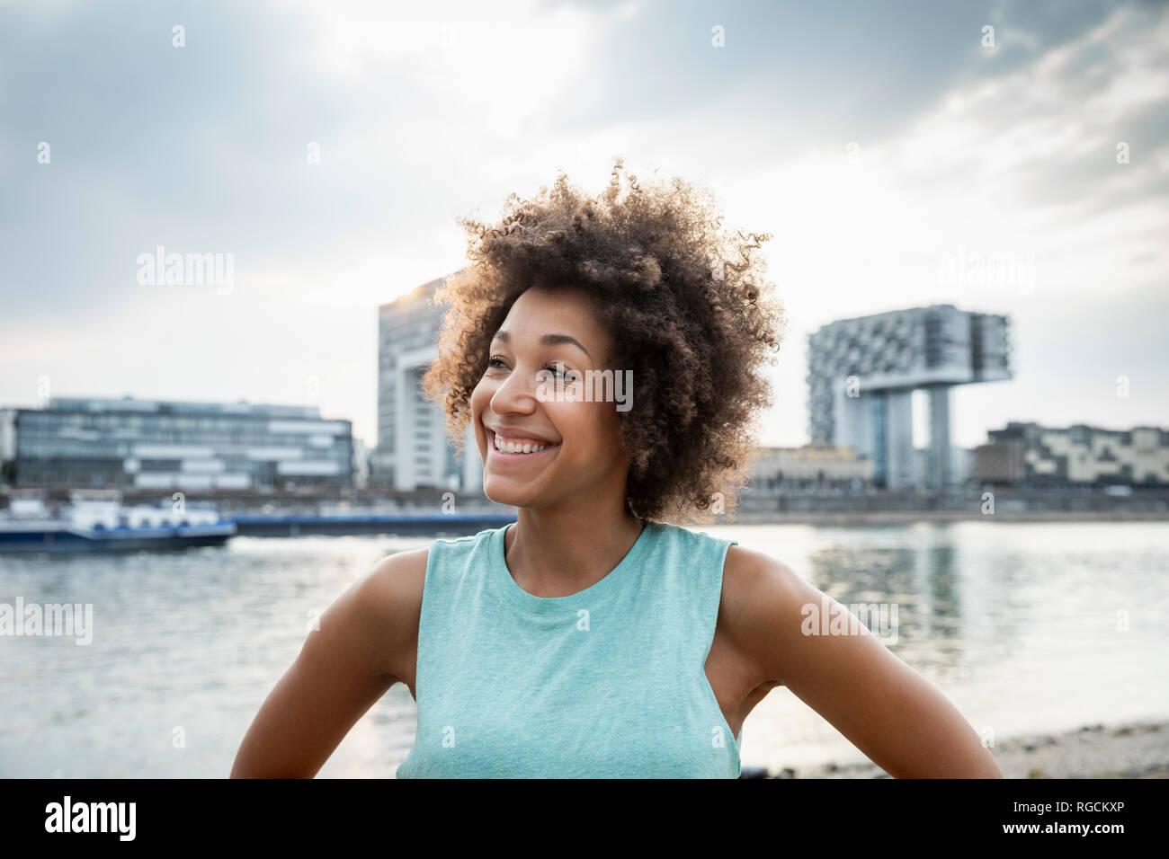 Germany, Cologne, portrait of happy woman at River Rhine Stock Photo