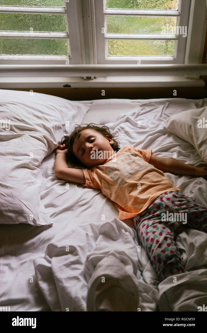 Baby girl sleeping on bed early in the morning Stock Photo Alamy