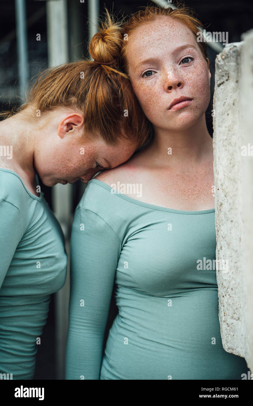 Redheaded twins, head supported Stock Photo