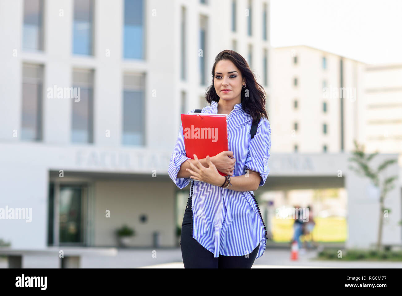Portrait of student with notebooks on campus Stock Photo