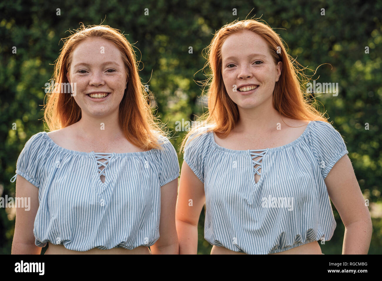 Smiling redheaded twins Stock Photo