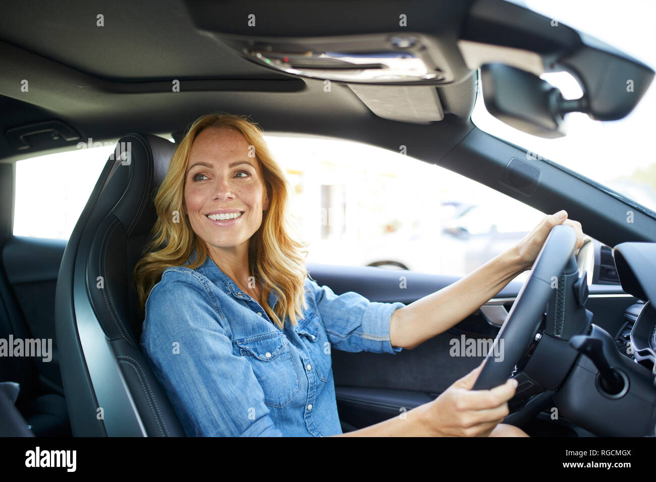 Smiling woman driving car Stock Photo