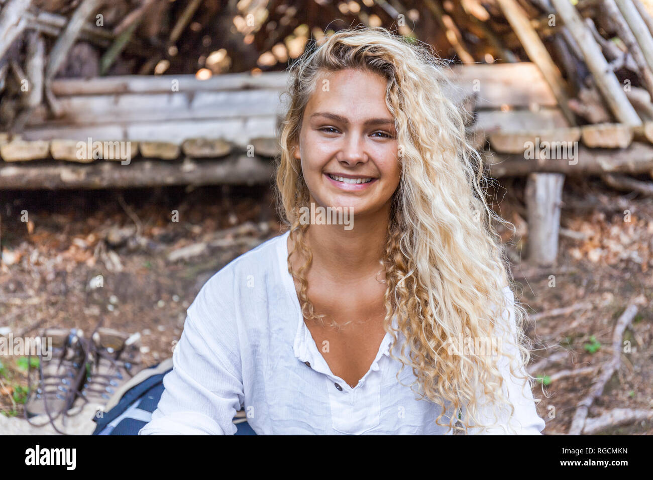 Portrait of smiling young woman at wooden shelter Stock Photo