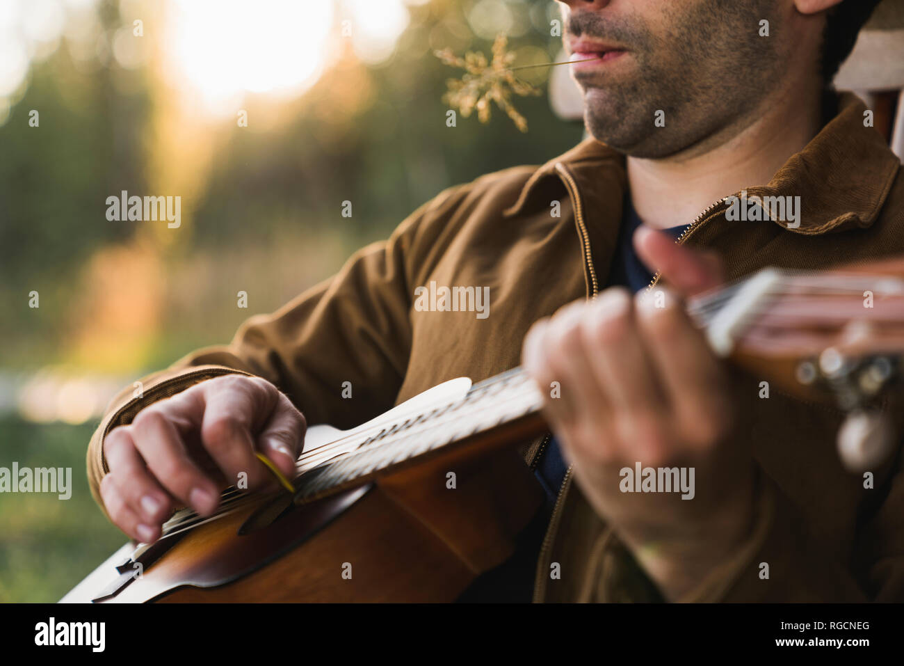 Close-up of young man, plaing the ukulele Stock Photo