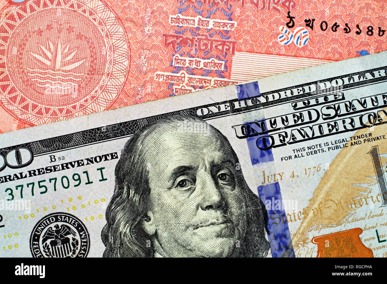 A Macro Image Of An American One Hundred Dollar Bill With A Red Bangladeshi Ten Taka Note Close Up Stock Photo Alamy