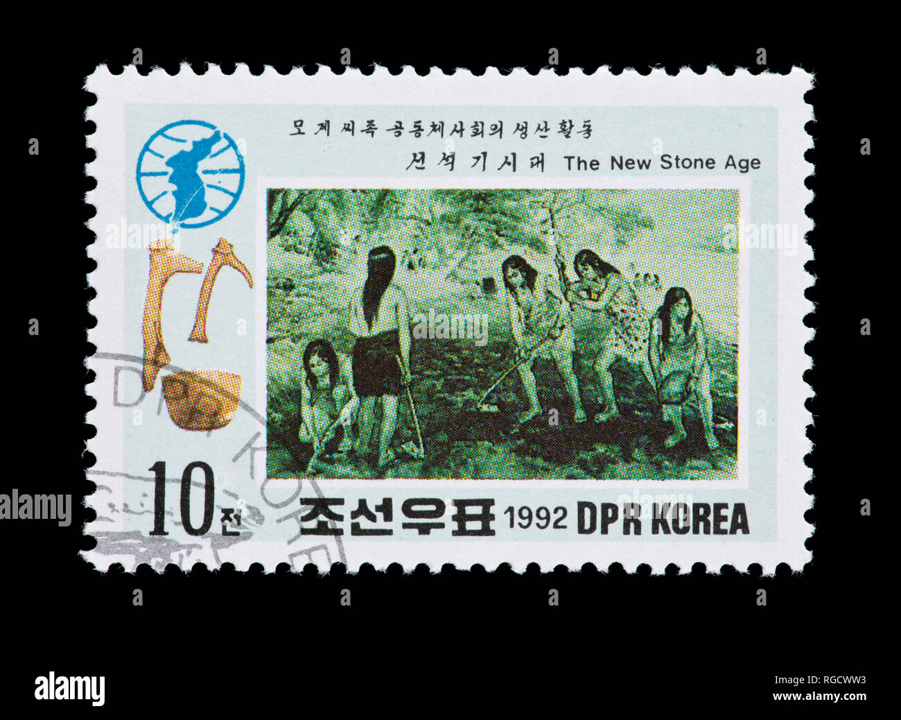 Postage stamp from North Korea depicting prehistoric people planting crops. Stock Photo