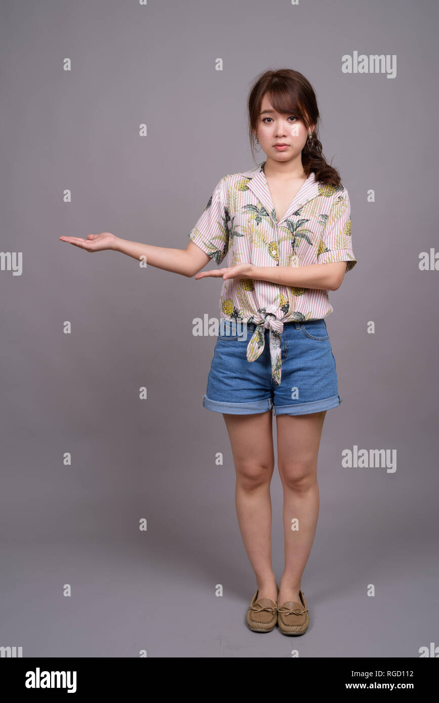 Full length portrait of beautiful young Asian woman standing Stock ...